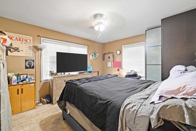 bedroom featuring ceiling fan and light colored carpet