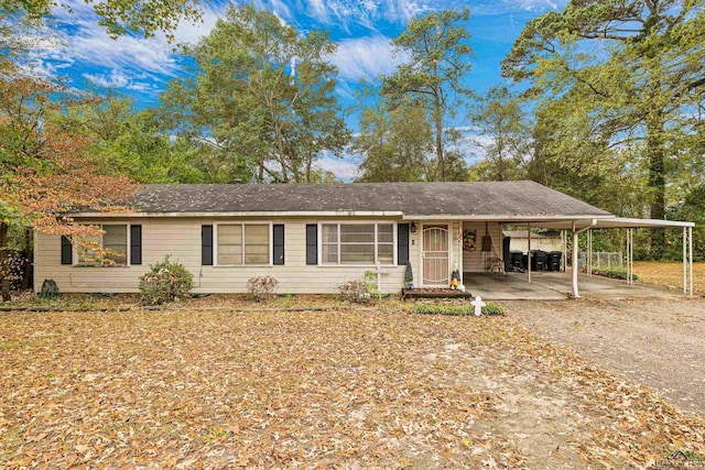 ranch-style house featuring a carport