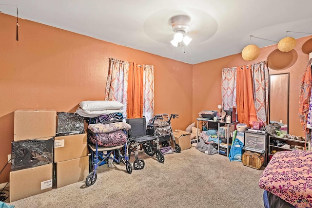 miscellaneous room with ceiling fan and carpet