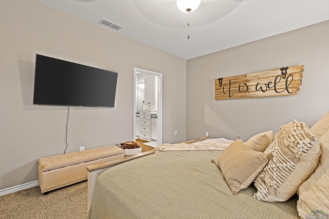 bedroom featuring ceiling fan, ensuite bathroom, and carpet