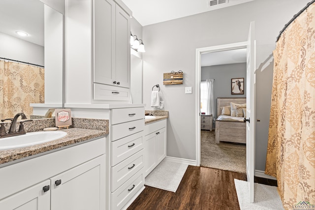 bathroom with hardwood / wood-style flooring and vanity