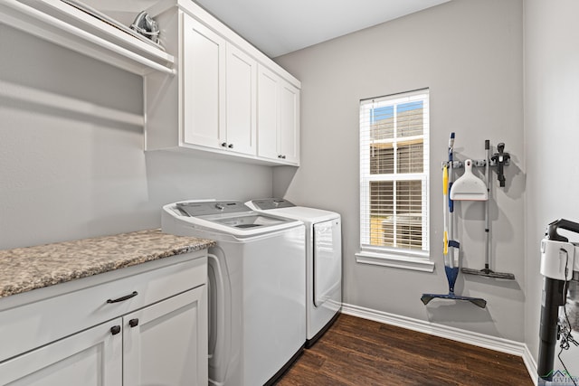 laundry area featuring cabinets, dark hardwood / wood-style flooring, and washer and dryer