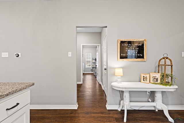 hall with dark wood-type flooring