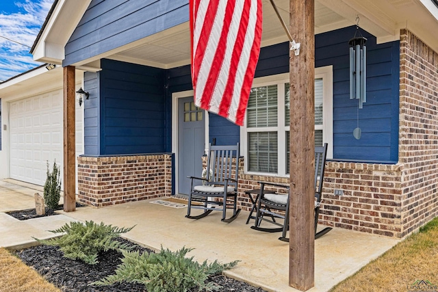 view of patio featuring a porch and a garage