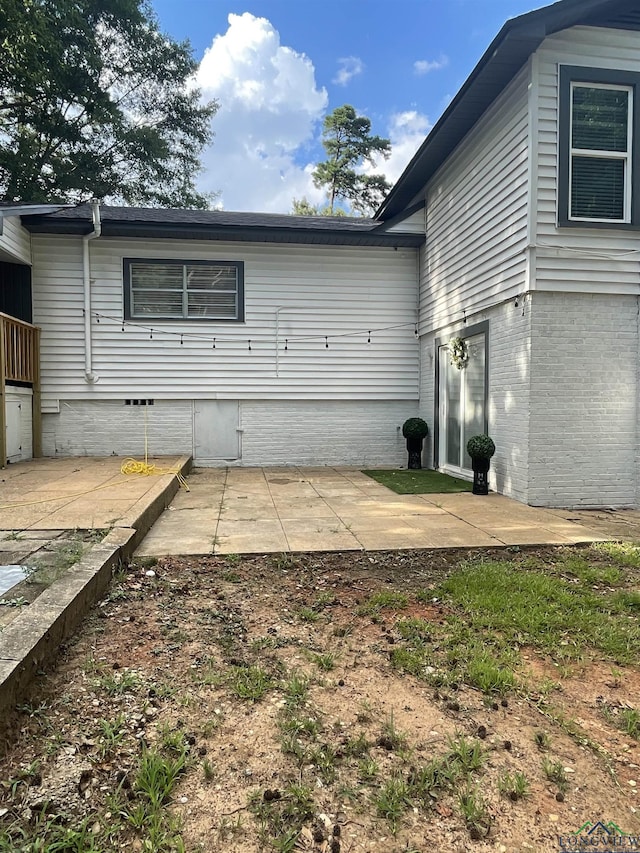 back of property with a patio