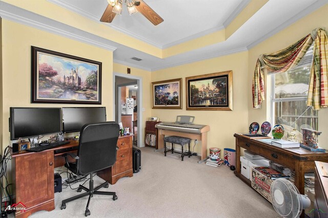office with ceiling fan, visible vents, ornamental molding, a tray ceiling, and carpet flooring