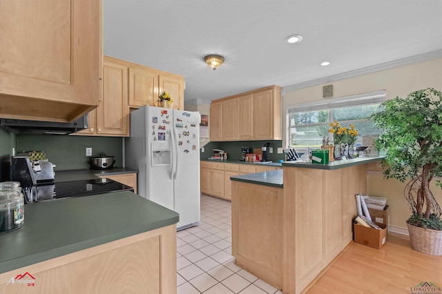 kitchen featuring a peninsula, light brown cabinetry, dark countertops, recessed lighting, and white fridge with ice dispenser