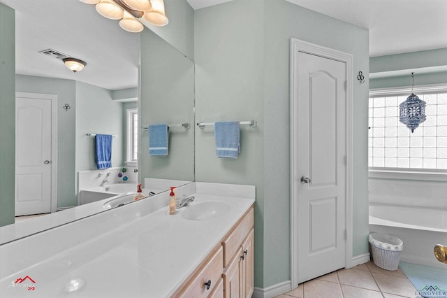 full bath featuring a garden tub, visible vents, tile patterned flooring, vanity, and baseboards