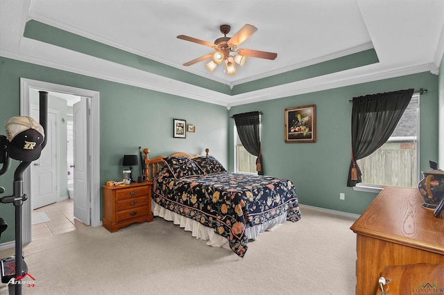carpeted bedroom with ornamental molding, a raised ceiling, and multiple windows