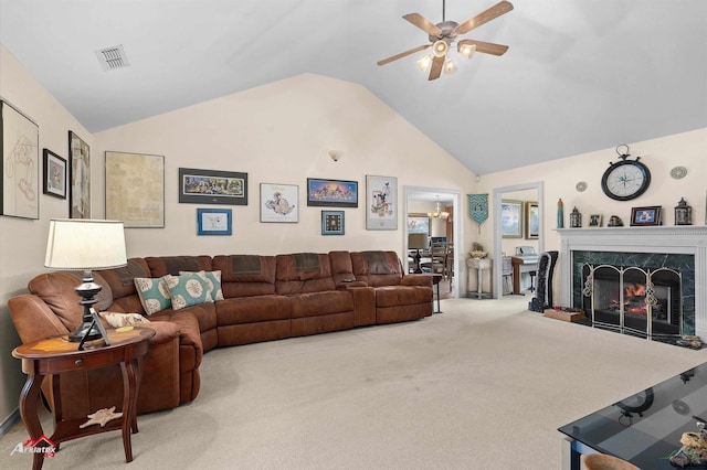 living area with carpet floors, a ceiling fan, lofted ceiling, a high end fireplace, and visible vents