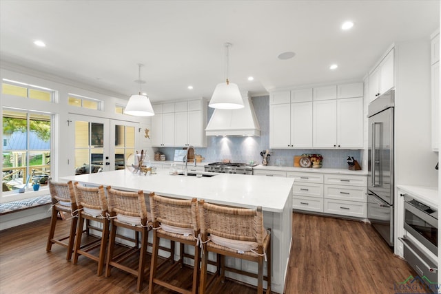 378 Cypress Creek Dr, Mount Vernon, TX 75457 - kitchen featuring built in refrigerator, premium range hood, light countertops, tasteful backsplash, and recessed lighting