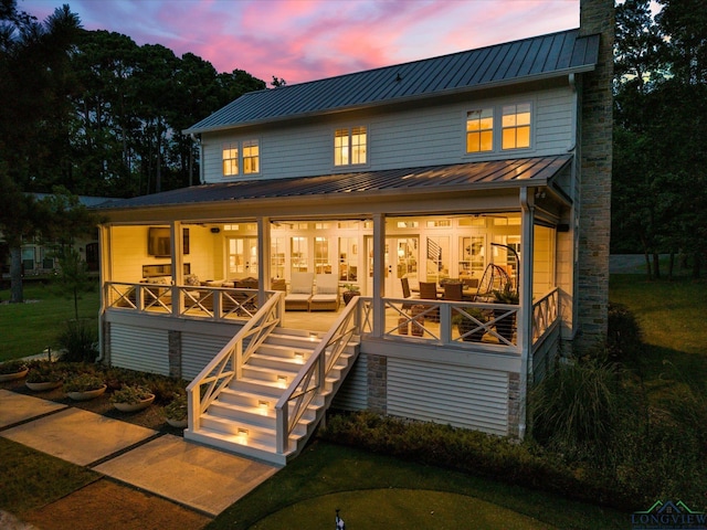 378 Cypress Creek Dr, Mount Vernon, TX 75457 - back of property with a standing seam roof, a metal roof, stairs, a chimney, and a lawn