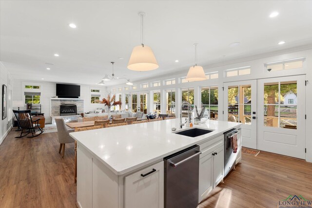 378 Cypress Creek Dr, Mount Vernon, TX 75457 - kitchen featuring dishwasher, recessed lighting, a center island with sink, a fireplace, and hanging light fixtures