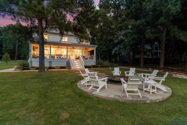 378 Cypress Creek Dr, Mount Vernon, TX 75457 - back of house at dusk featuring a fire pit, a sunroom, stairs, and a yard