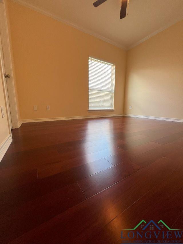 empty room with crown molding, ceiling fan, and dark hardwood / wood-style flooring