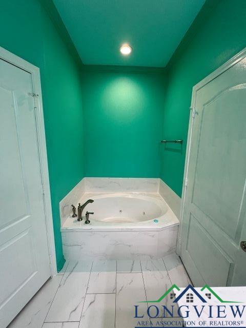 bathroom with a tub to relax in