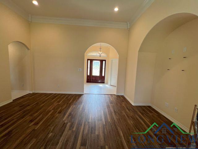 interior space with ornamental molding and dark hardwood / wood-style flooring