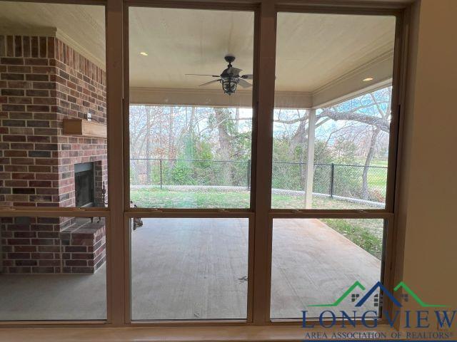 entryway with a wealth of natural light and ceiling fan