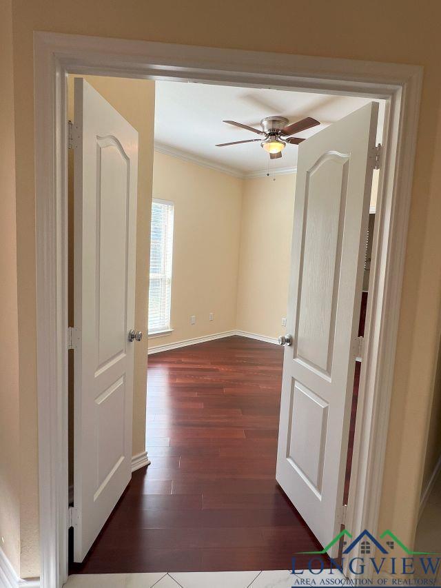 hall with ornamental molding and dark hardwood / wood-style flooring