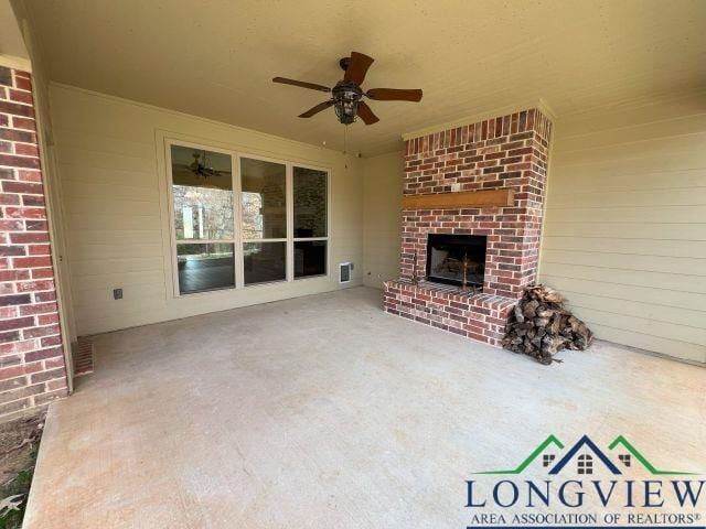 view of patio / terrace featuring an outdoor brick fireplace and ceiling fan