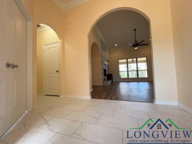 hallway featuring ornamental molding