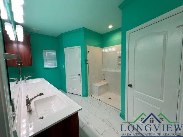 bathroom featuring vanity and an enclosed shower