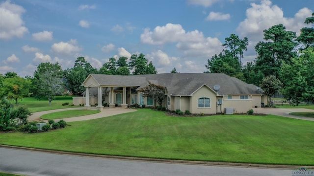 ranch-style house with cooling unit and a front yard