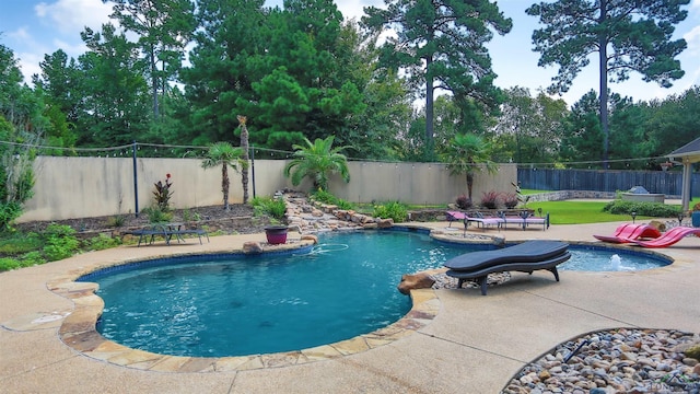 view of pool with pool water feature and a patio