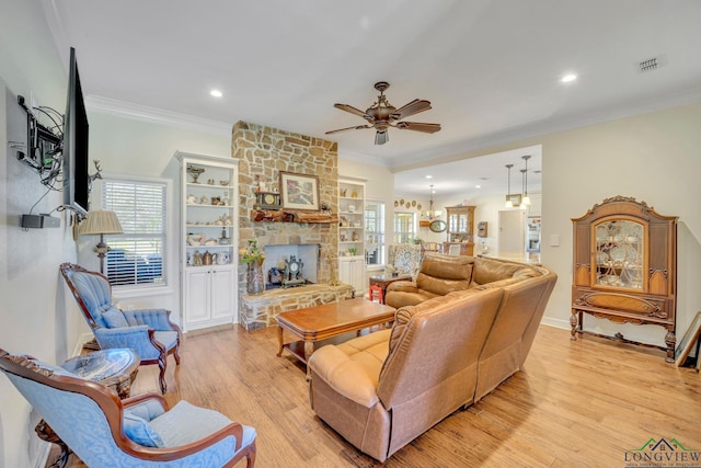 living room with ceiling fan, light wood-type flooring, and crown molding