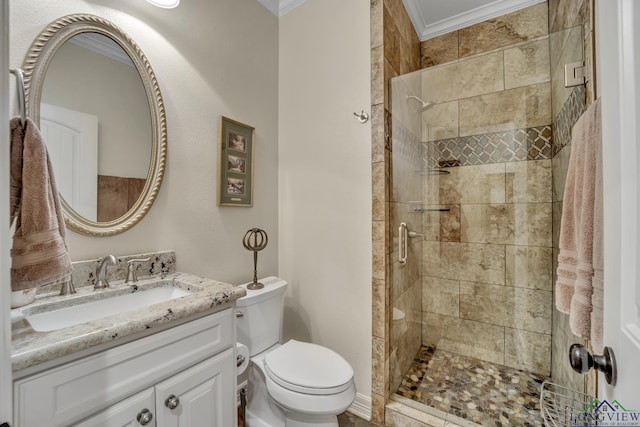 bathroom with toilet, a shower with door, vanity, and ornamental molding