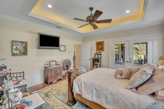 bedroom featuring french doors, access to outside, a raised ceiling, and ceiling fan