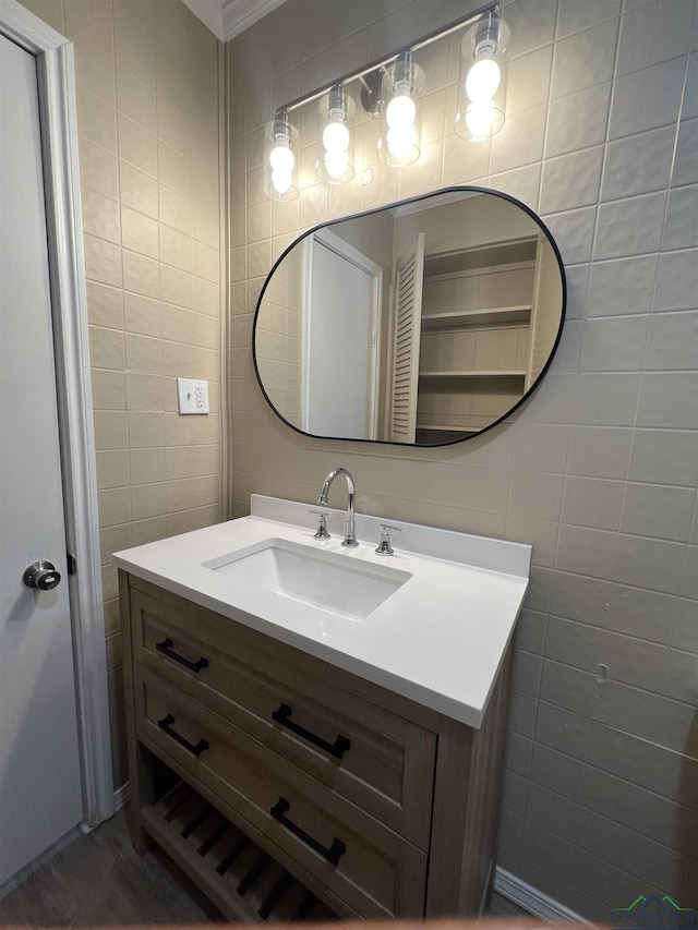 714 W Quitman Ave, Gladewater, TX 75647 - bathroom featuring tile walls, vanity, and ornamental molding