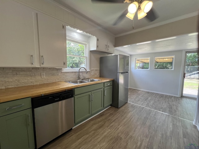 714 W Quitman Ave, Gladewater, TX 75647 - kitchen with green cabinetry, stainless steel appliances, a sink, butcher block counters, and crown molding