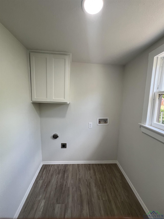 714 W Quitman Ave, Gladewater, TX 75647 - washroom with washer hookup, cabinet space, dark wood-style floors, and baseboards