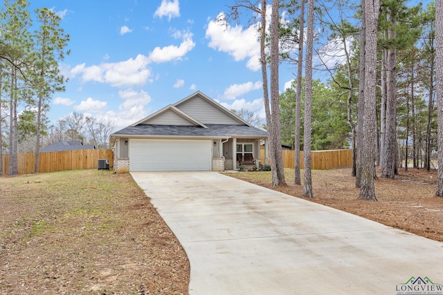 view of front of house featuring a garage and central AC