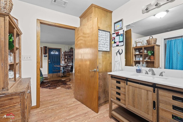 bathroom featuring vanity, wood finished floors, and visible vents