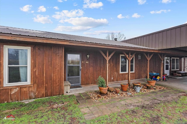 view of front of property with board and batten siding and metal roof