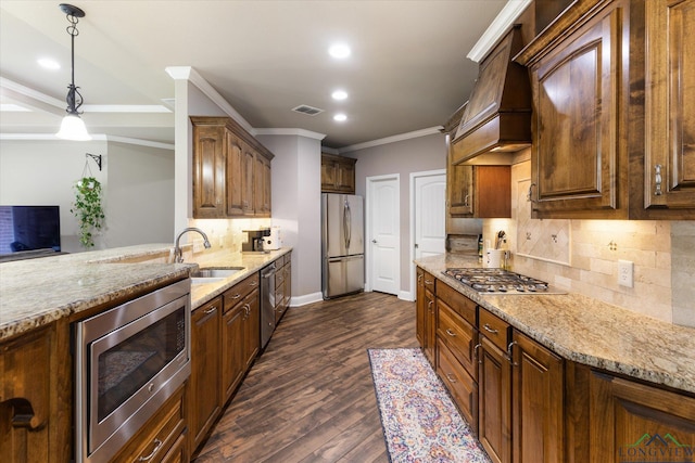 kitchen featuring crown molding, a sink, appliances with stainless steel finishes, and recessed lighting