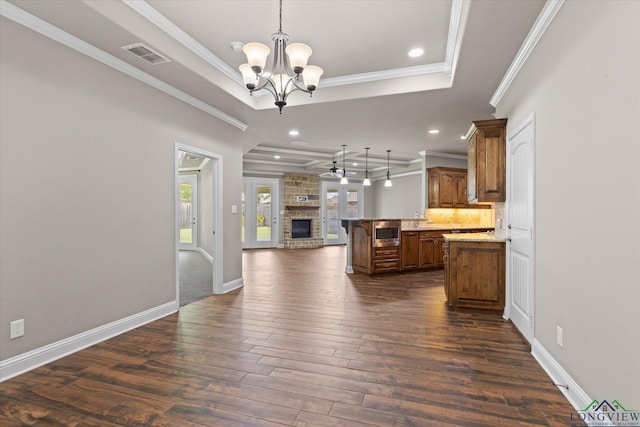 3363 Celebration Way, Longview, TX 75605 - kitchen with open floor plan, a raised ceiling, a chandelier, dark wood-style floors, and stainless steel microwave
