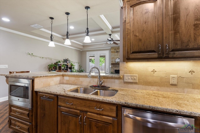 kitchen with a sink, ornamental molding, a ceiling fan, and stainless steel appliances
