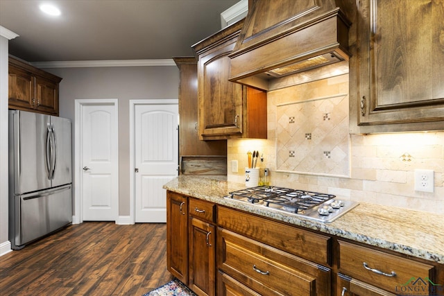 kitchen with decorative backsplash, light stone countertops, appliances with stainless steel finishes, and ornamental molding