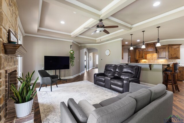 living area with a fireplace, baseboards, dark wood-style floors, arched walkways, and coffered ceiling