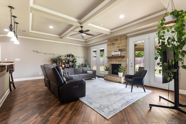 living room with visible vents, crown molding, a fireplace, dark wood-style floors, and coffered ceiling