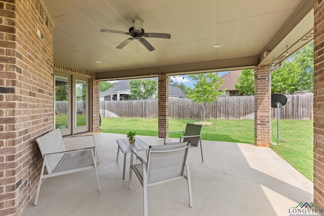 view of patio / terrace featuring ceiling fan, french doors, and a fenced backyard