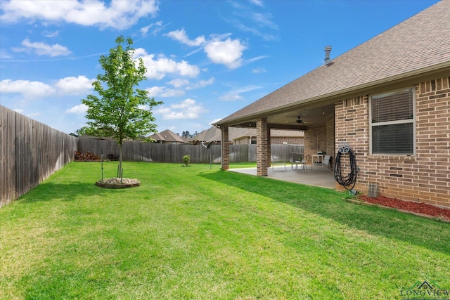 view of yard with a patio, a ceiling fan, and a fenced backyard