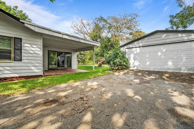 exterior space featuring a garage and an outdoor structure