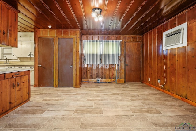 kitchen featuring a wall mounted air conditioner, wood walls, and wooden ceiling