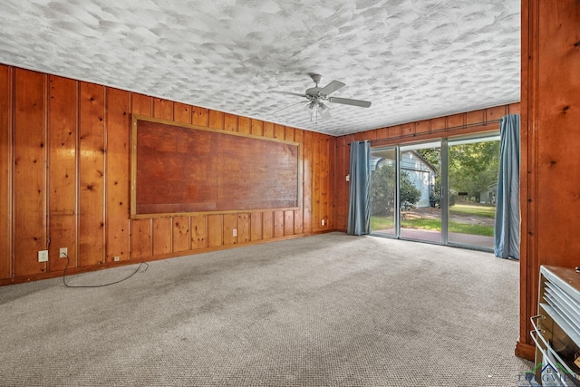 carpeted spare room with ceiling fan and a textured ceiling