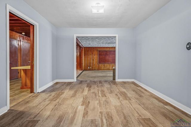 hallway featuring wood walls and hardwood / wood-style flooring