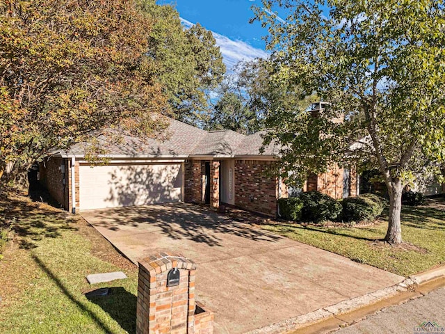 view of front facade with a front yard and a garage